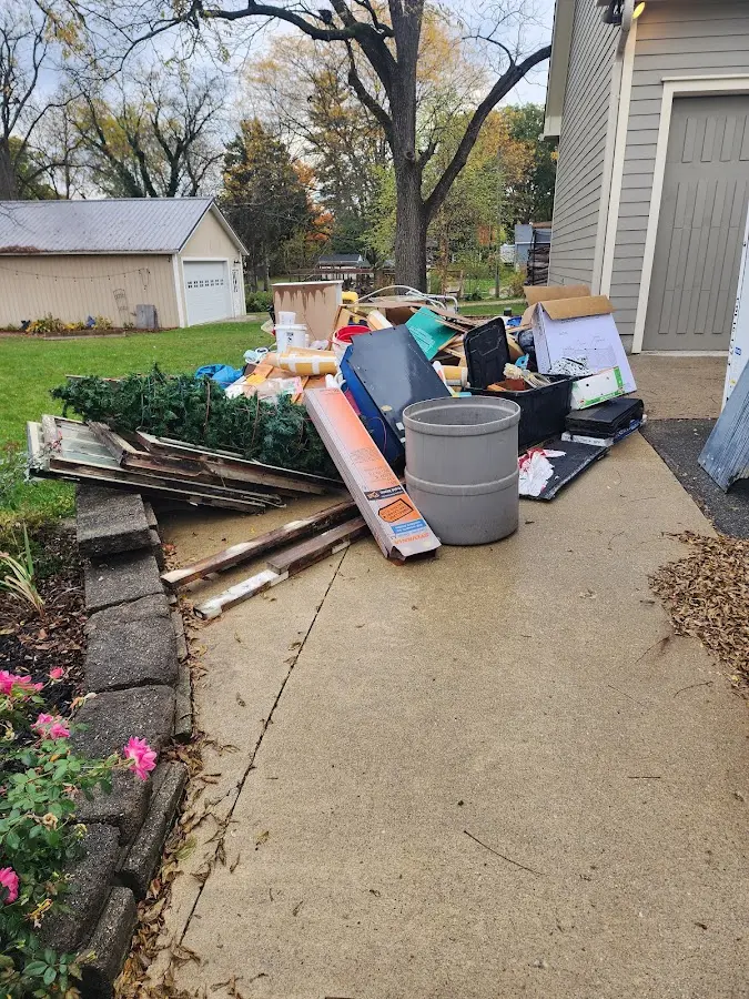 Dumpster being loaded with debris for Commercial Dumpster Rental in Greenfield